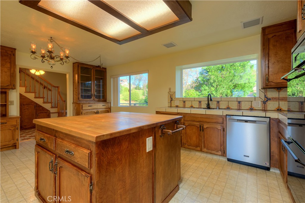 217 Craft Paradise, CA 95969 - Photo 11 of 62 a kitchen with kitchen island granite countertop a sink a counter top space and stainless steel appliances