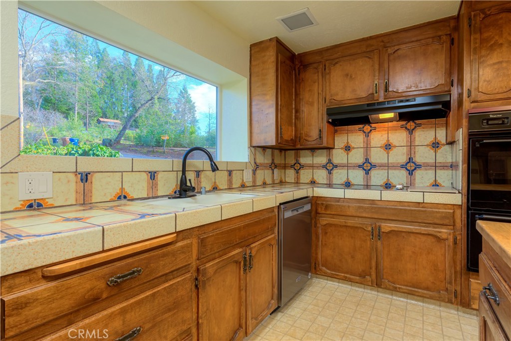 217 Craft Paradise, CA 95969 - Photo 12 of 62 a kitchen with stainless steel appliances granite countertop a sink and a microwave