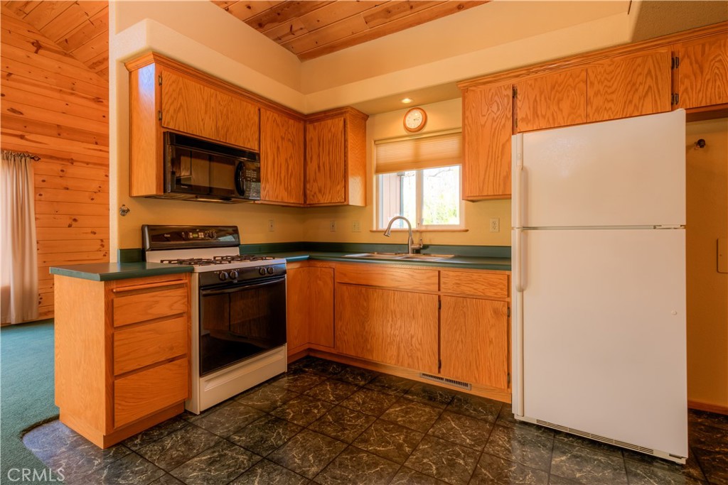 217 Craft Paradise, CA 95969 - Photo 33 of 62 a kitchen with stainless steel appliances granite countertop a refrigerator a stove a sink and a microwave