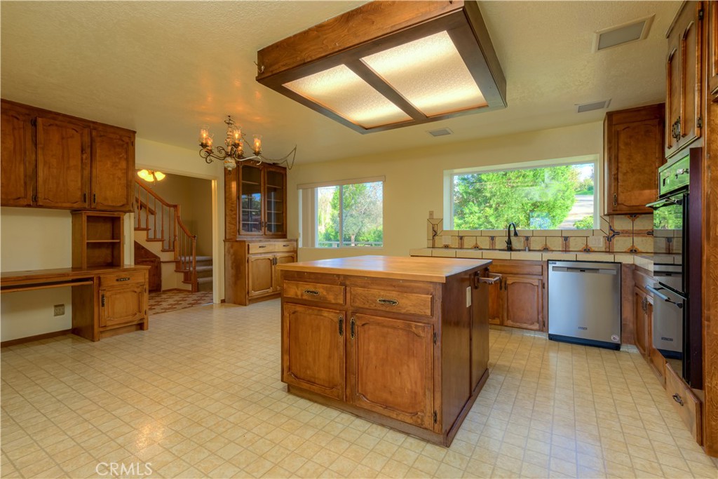 217 Craft Paradise, CA 95969 - Photo 8 of 62 a kitchen with stainless steel appliances kitchen island granite countertop a stove a sink and a refrigerator