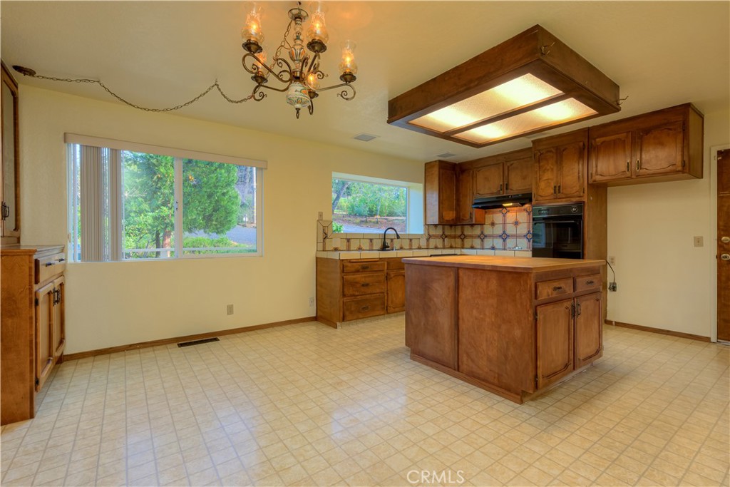 217 Craft Paradise, CA 95969 - Photo 9 of 62 a kitchen with stainless steel appliances granite countertop a stove a sink dishwasher and a refrigerator with wooden floor