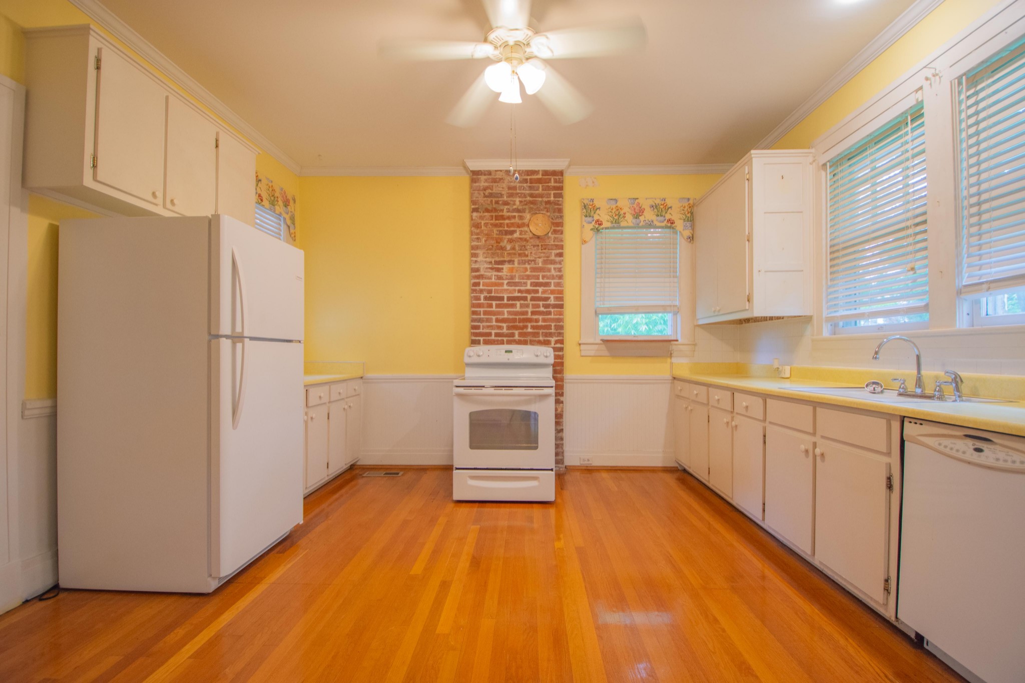 311 South 3rd Street Pulaski, TN 38478 - Photo 5 of 44 a view of a kitchen with wooden floor and electronic appliances