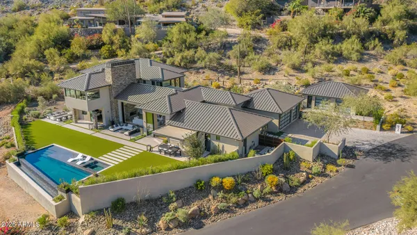 an aerial view of a house with a swimming pool