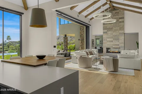 a living room with fireplace furniture and a floor to ceiling window