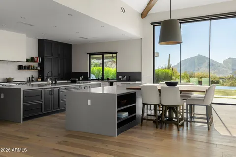 a living room with furniture flat screen tv and windows