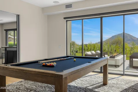 a bathroom with a granite countertop sink a mirror a toilet and a shower