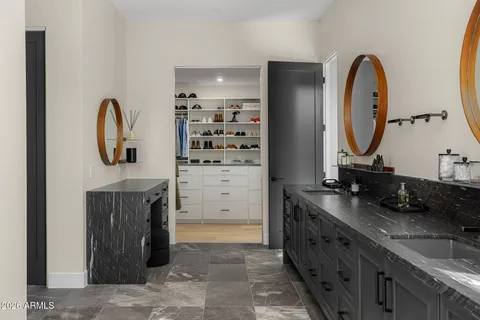 a living room with furniture and a mirror