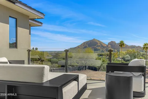 a view of a house with swimming pool and sitting area