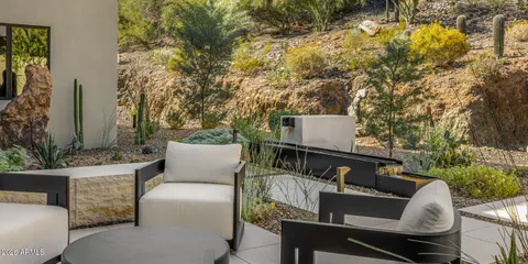 a dining room with furniture and a floor to ceiling window