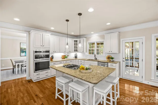 a kitchen with a stove a sink and a refrigerator