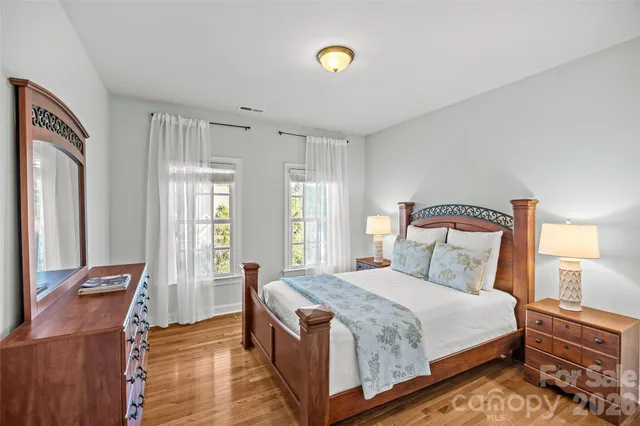 a bedroom with a bed and a dresser with mirror