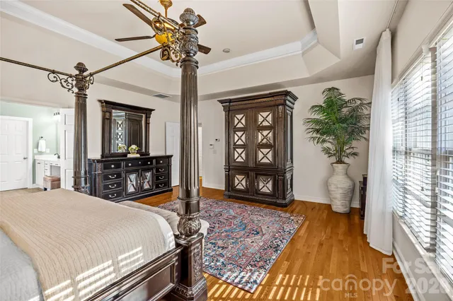 a bedroom with a bed closet and wooden floor