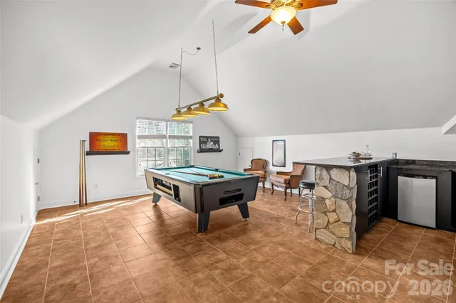 a living room with furniture a rug and a ceiling fan