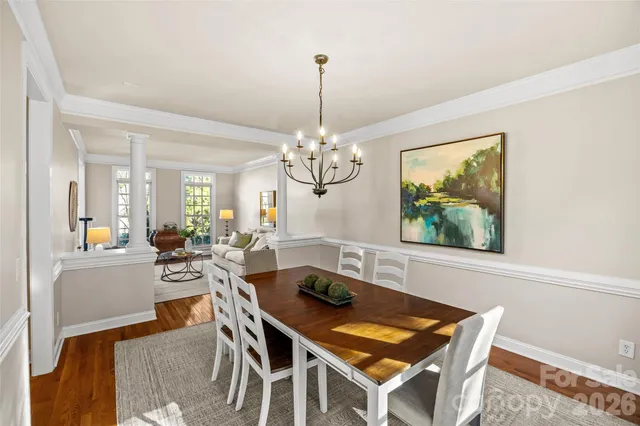 a view of a dining room with furniture wooden floor and a chandelier