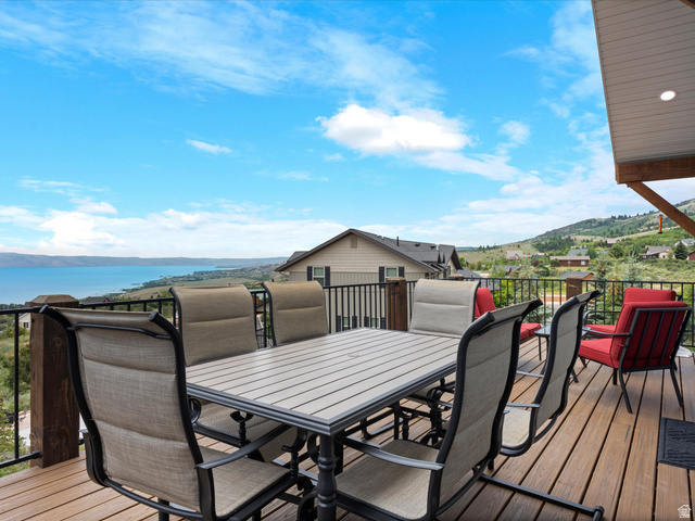 608 Fremont Road Fish Haven, ID 83287 - Photo 6 of 35 Expansive wood-finish deck featuring a black metal railing and a large lake backdrop