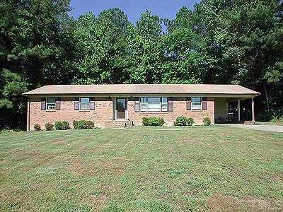 4913 Mandel Road Durham, NC 27712 - Photo 1 of 1 Front exterior view with brick exterior, concrete driveway & sidewalk, one car carport on level .46 acre lot.