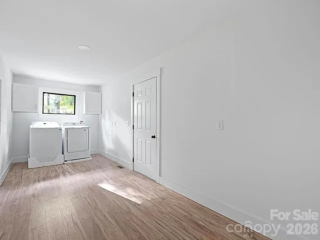 a view of a livingroom with wooden floor and a window