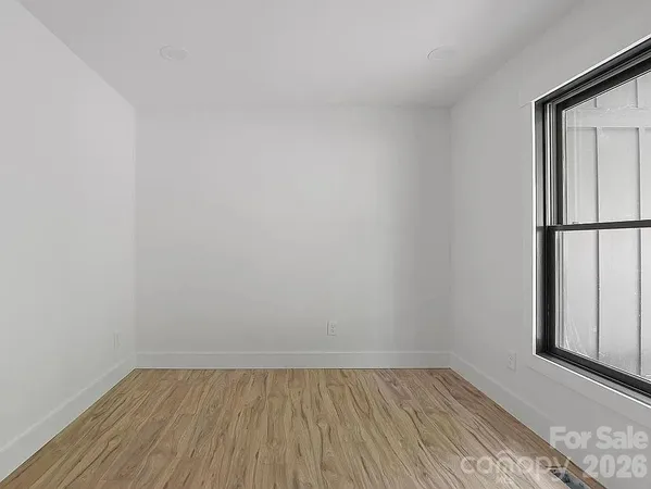 a view of an empty room and wooden floor
