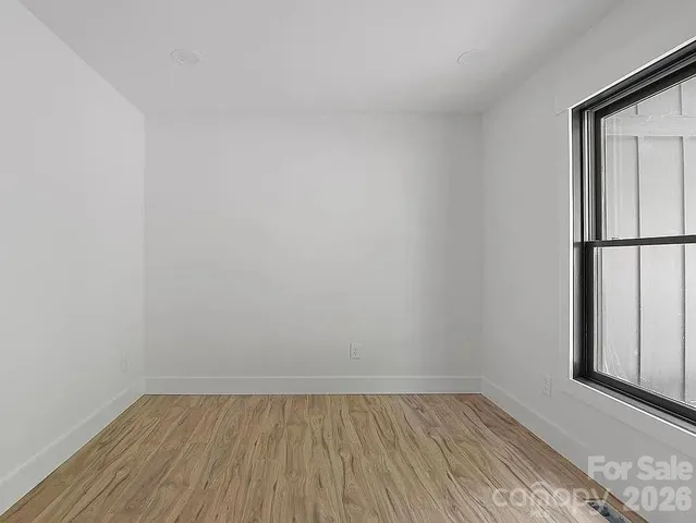 a view of an empty room and wooden floor