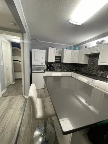 a kitchen with stainless steel appliances granite countertop a sink refrigerator and cabinets