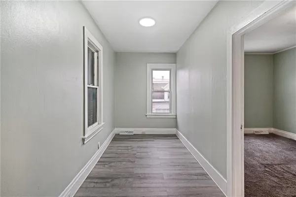 a view of a room with wooden floor