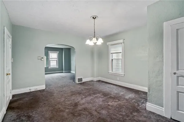 a view of a room with windows and chandelier