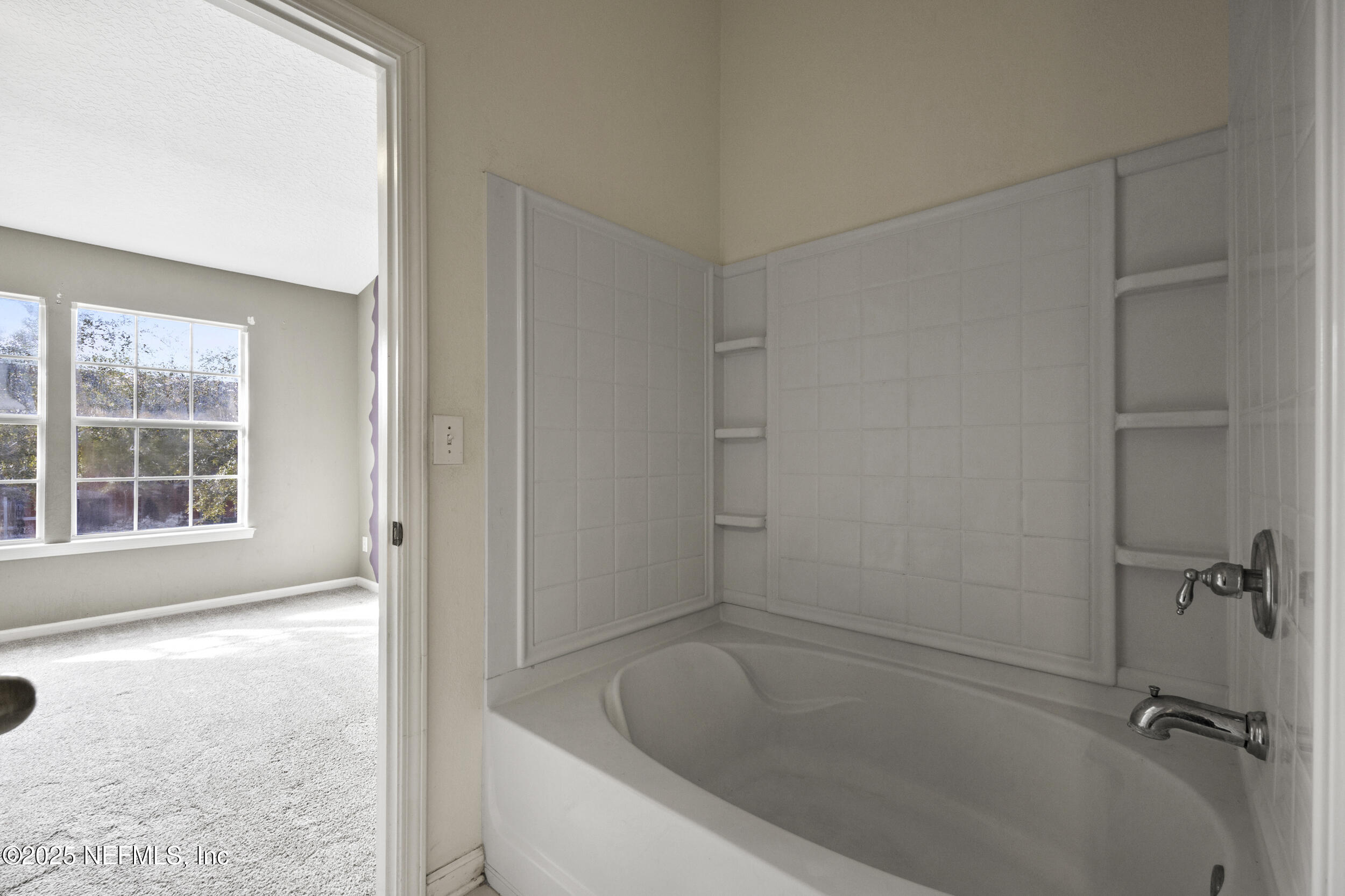 13309 Solar Drive Jacksonville, FL 32258 - Photo 17 of 29 a white bath tub sitting next to a window