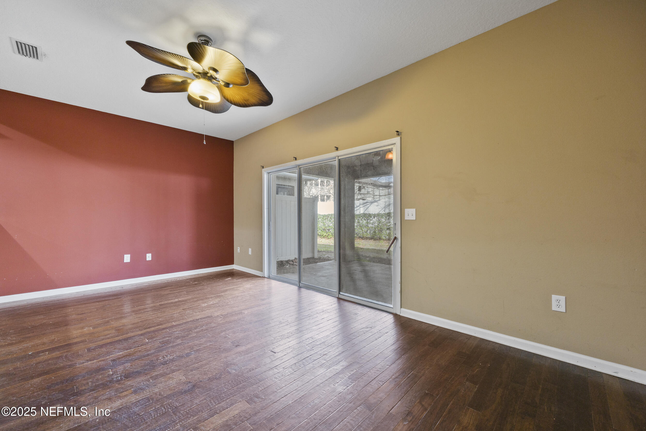 13309 Solar Drive Jacksonville, FL 32258 - Photo 4 of 29 a view of an empty room with wooden floor and a window