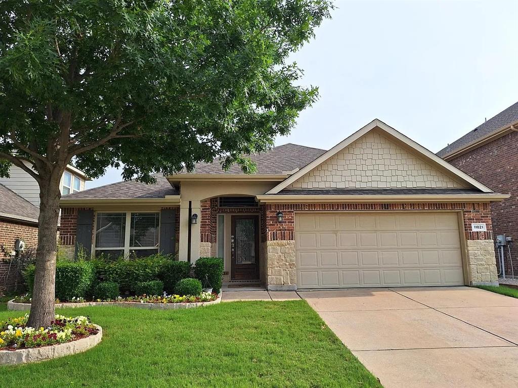 11821 Beach Street Frisco, TX 75036 - Photo 1 of 38 a front view of a house with a yard and garage