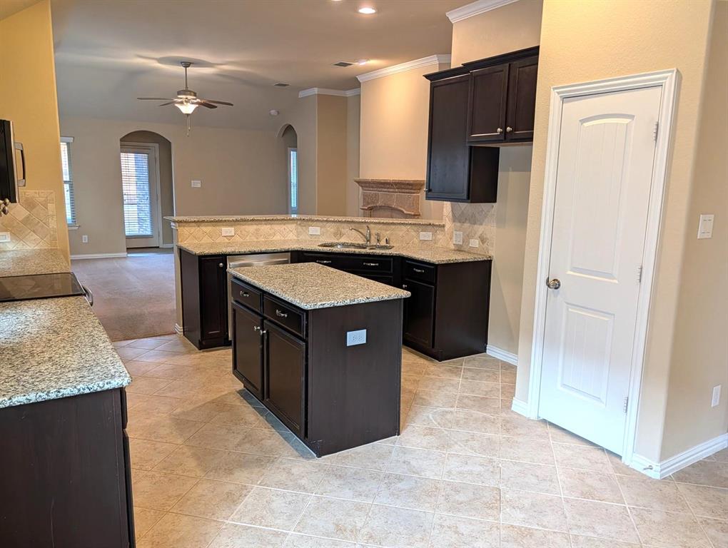11821 Beach Street Frisco, TX 75036 - Photo 11 of 38 Kitchen featuring a peninsula, backsplash, ceiling fan, light stone counters, and light tile patterned flooring