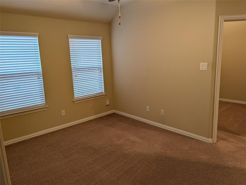 11821 Beach Street Frisco, TX 75036 - Photo 12 of 38 Unfurnished room with dark carpet and a ceiling fan