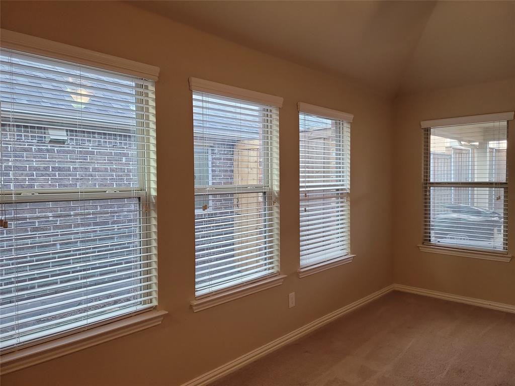 11821 Beach Street Frisco, TX 75036 - Photo 18 of 38 Carpeted spare room with lofted ceiling and baseboards