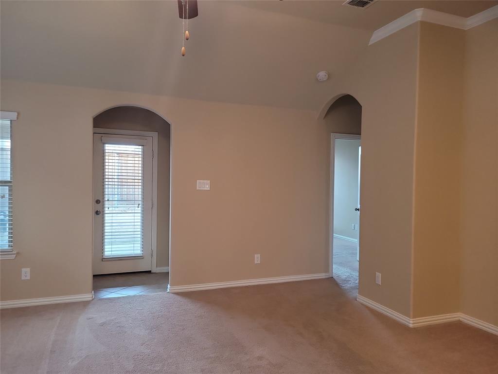 11821 Beach Street Frisco, TX 75036 - Photo 21 of 38 Empty room featuring arched walkways, a ceiling fan, and light colored carpet