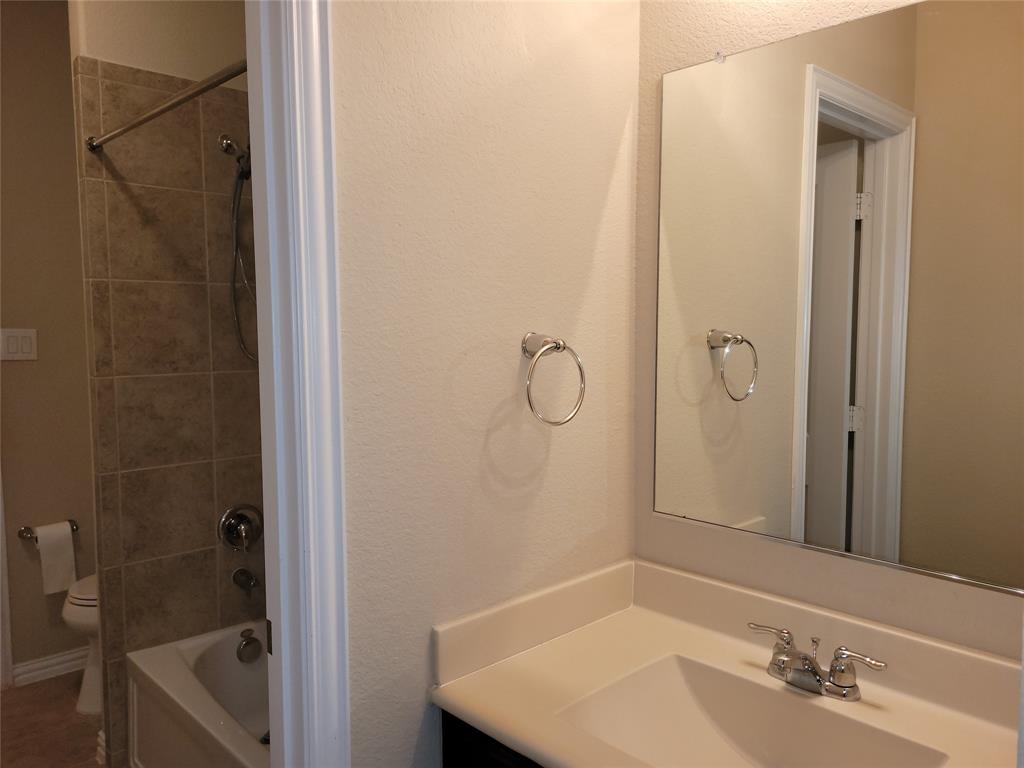 11821 Beach Street Frisco, TX 75036 - Photo 26 of 38 a bathroom with a sink and a mirror
