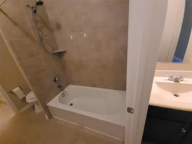 an empty room with a window and a chandelier fan