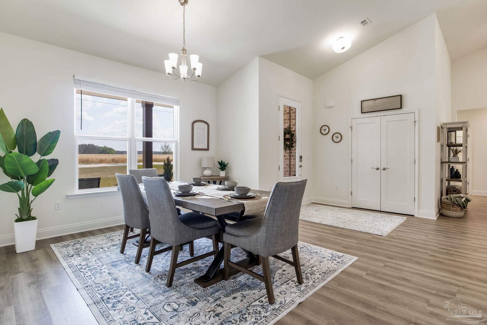 4404 Russell Elliott Road Jay, FL 32565 - Photo 19 of 62 a view of a dining room with furniture window and wooden floor