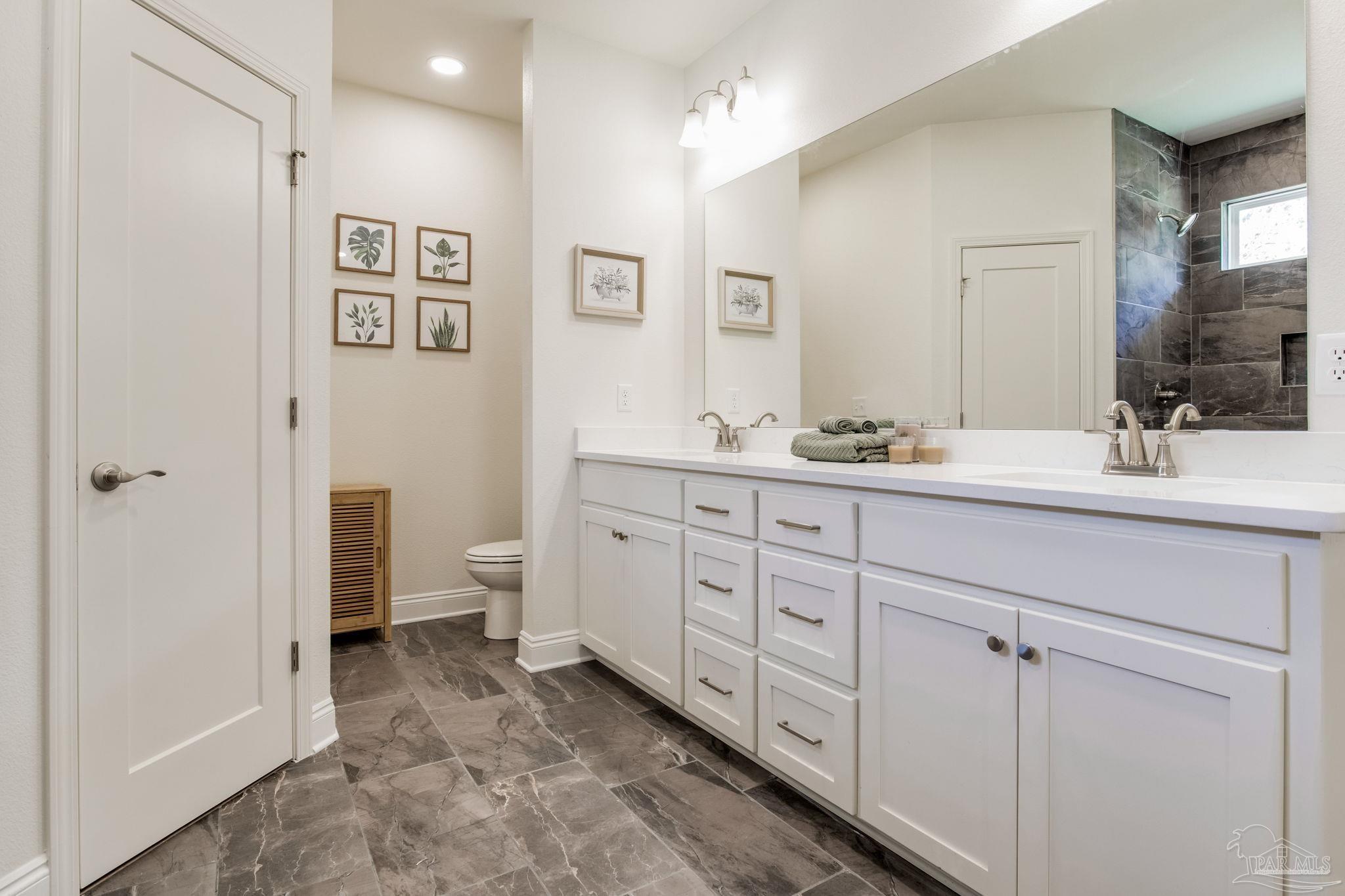 4404 Russell Elliott Road Jay, FL 32565 - Photo 33 of 62 a spacious bathroom with double sink and a mirror