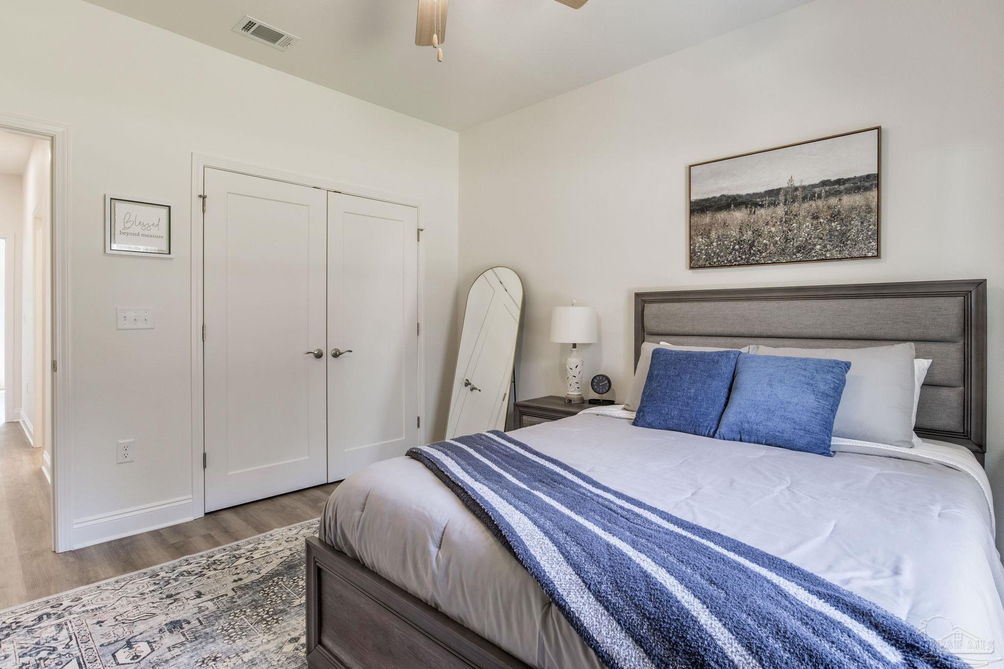 4404 Russell Elliott Road Jay, FL 32565 - Photo 39 of 62 a bedroom with a large bed and a painting on the wall