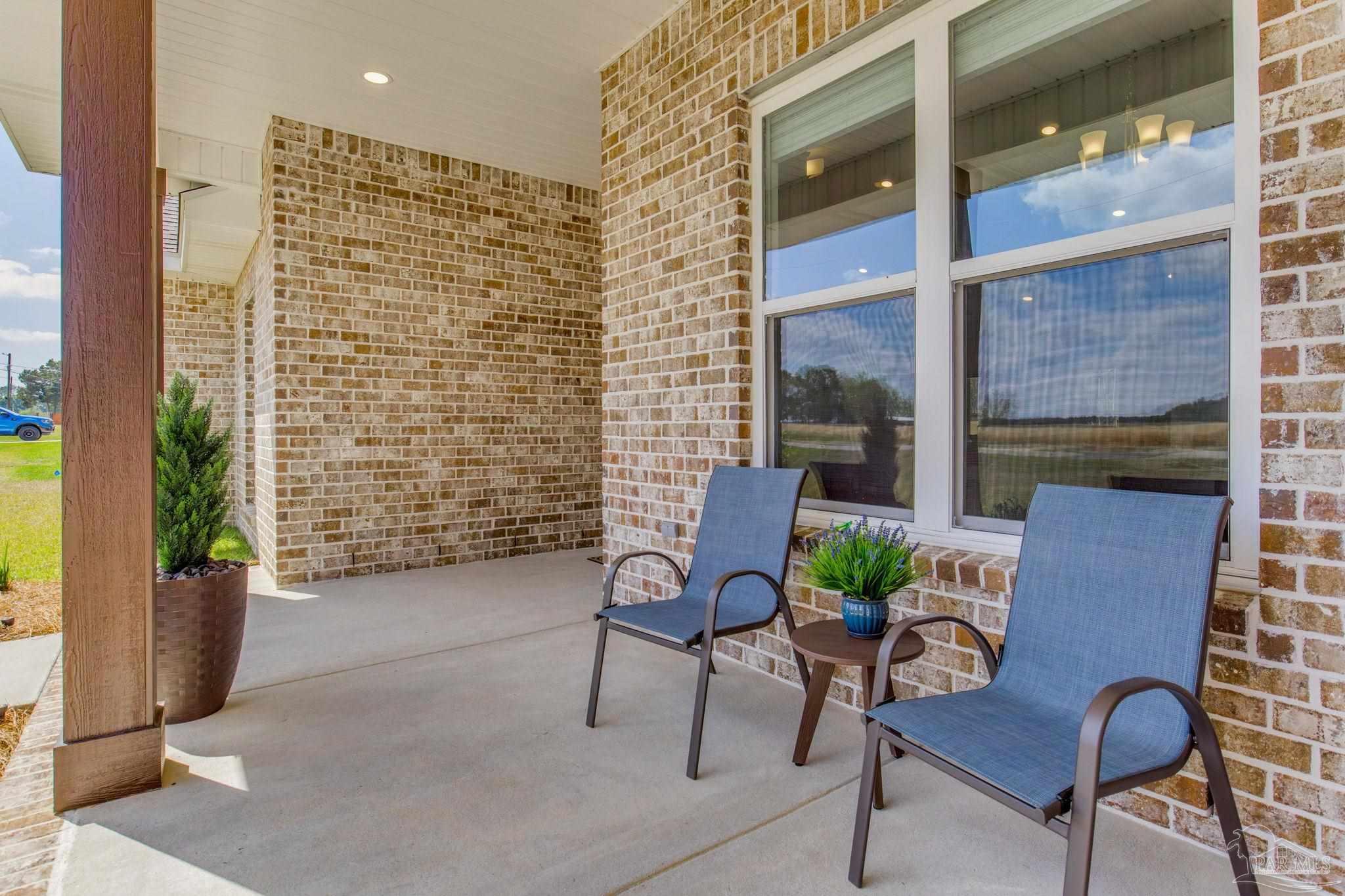 4404 Russell Elliott Road Jay, FL 32565 - Photo 4 of 62 a view of a porch with chairs and a potted plant