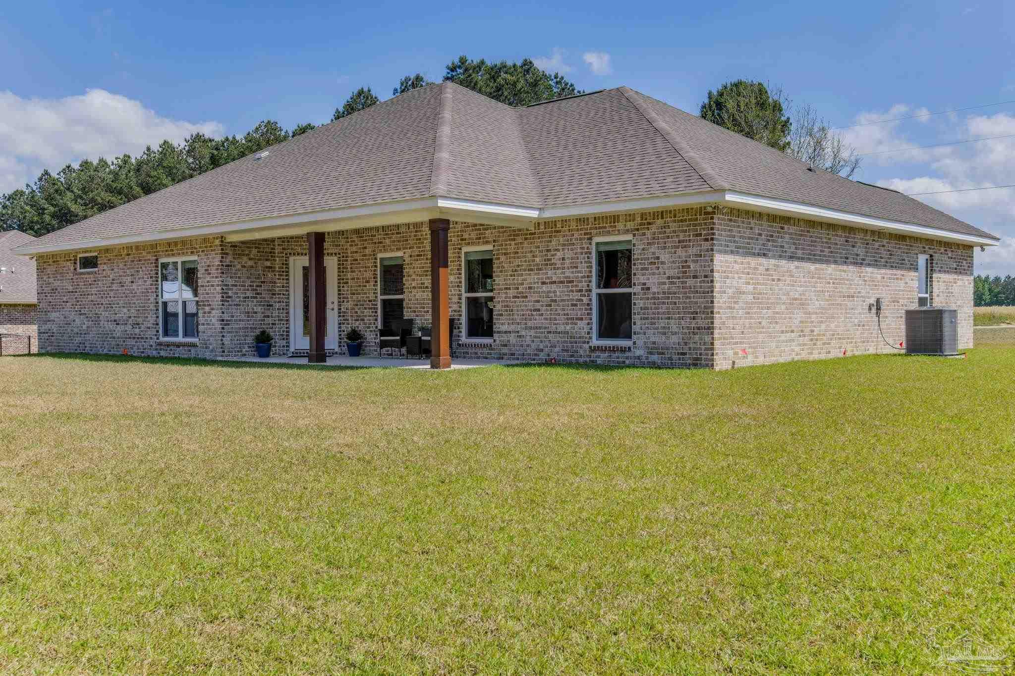 4404 Russell Elliott Road Jay, FL 32565 - Photo 56 of 62 a front view of house with yard and green space