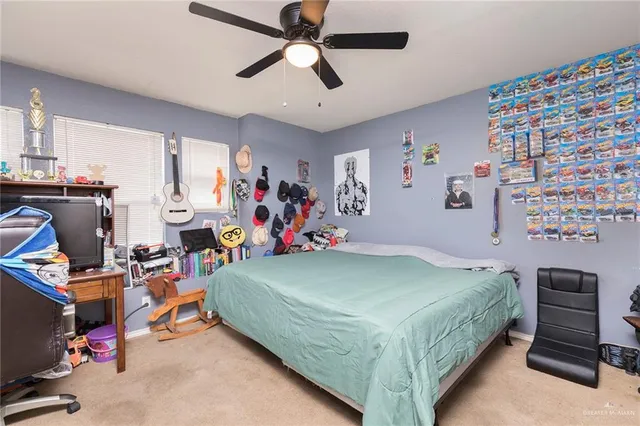 a bedroom with a bed and a flat tv screen