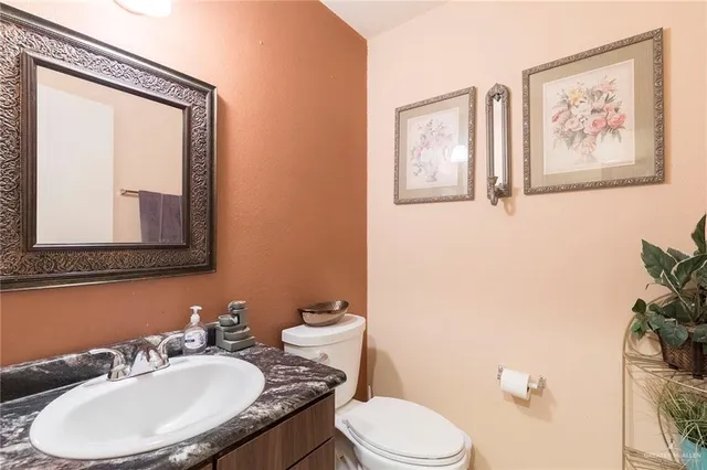 a bathroom with a toilet a sink and mirror