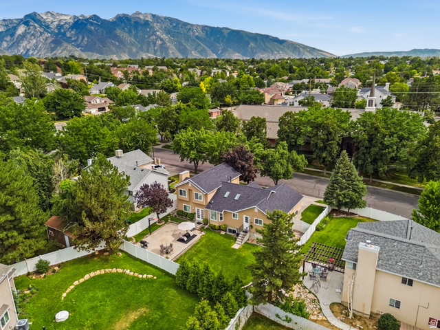 1101 Old Dairy Road Sandy, UT 84094 - Photo 41 of 41 Expansive backyard featuring a large green lawn, paved patio, and white privacy fencing