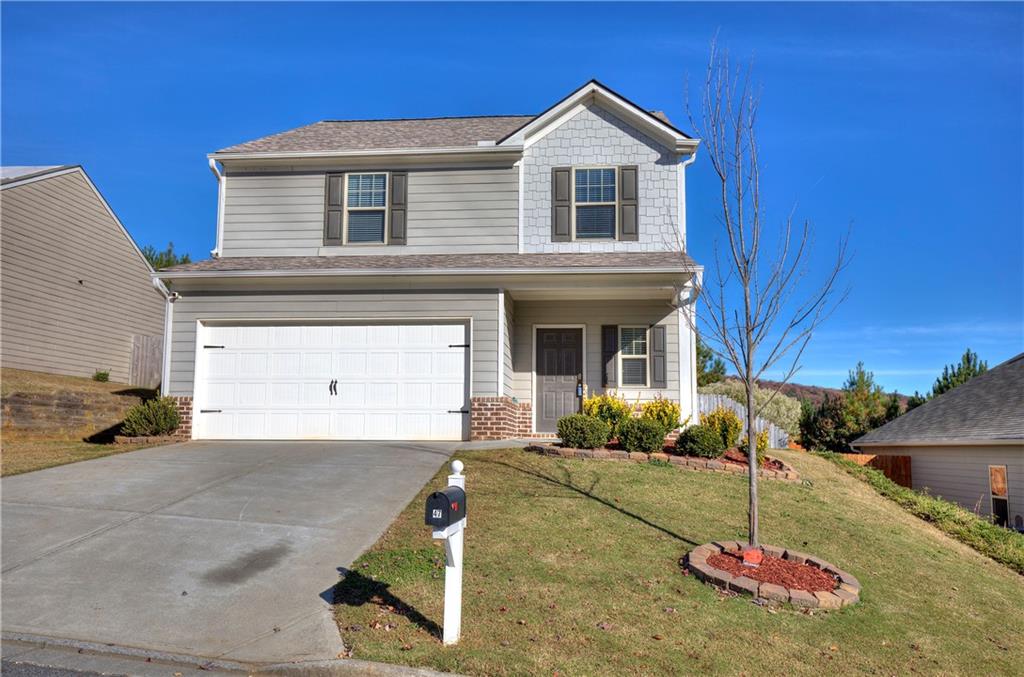 a front view of a house with a yard