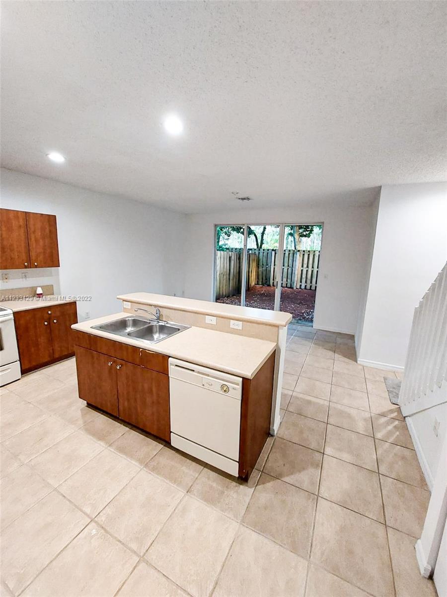 4282 Northeast 9th Street, Unit 4282 Homestead, FL 33033 - Photo 11 of 28 a kitchen with stainless steel appliances a stove a sink and a refrigerator