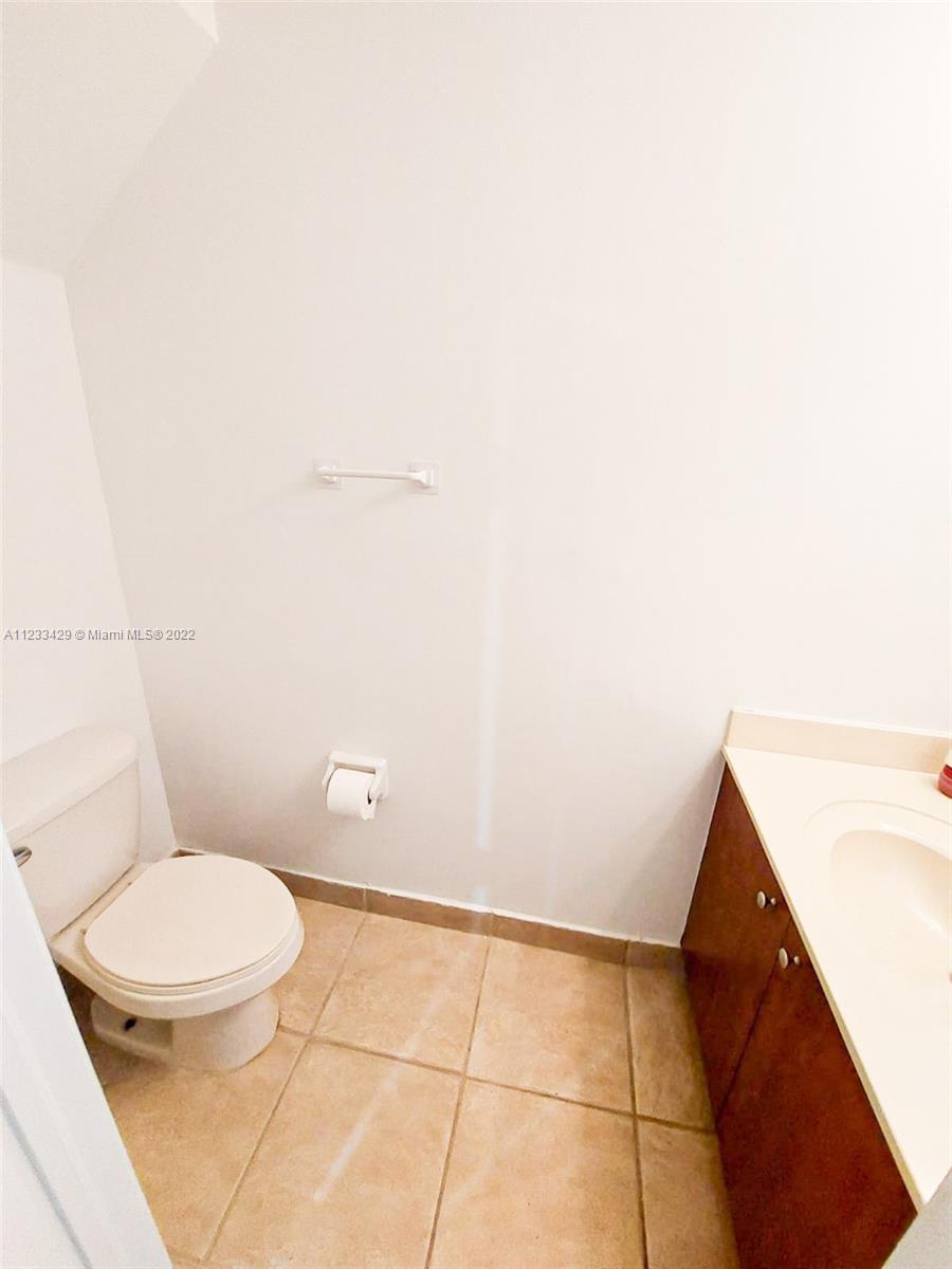 4282 Northeast 9th Street, Unit 4282 Homestead, FL 33033 - Photo 12 of 28 a bathroom with a toilet and a vanity