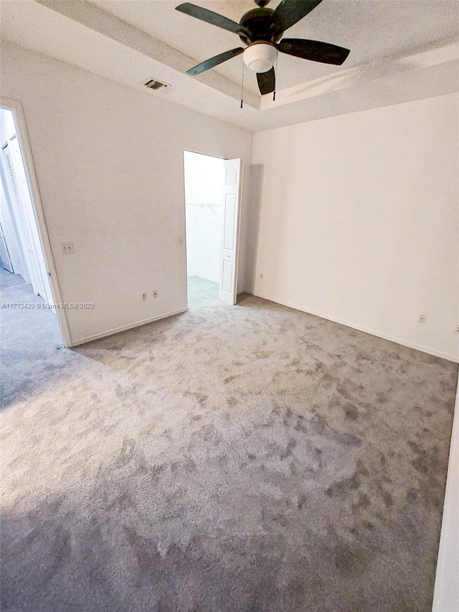 4282 Northeast 9th Street, Unit 4282 Homestead, FL 33033 - Photo 19 of 28 en empty room with ceiling fan and window