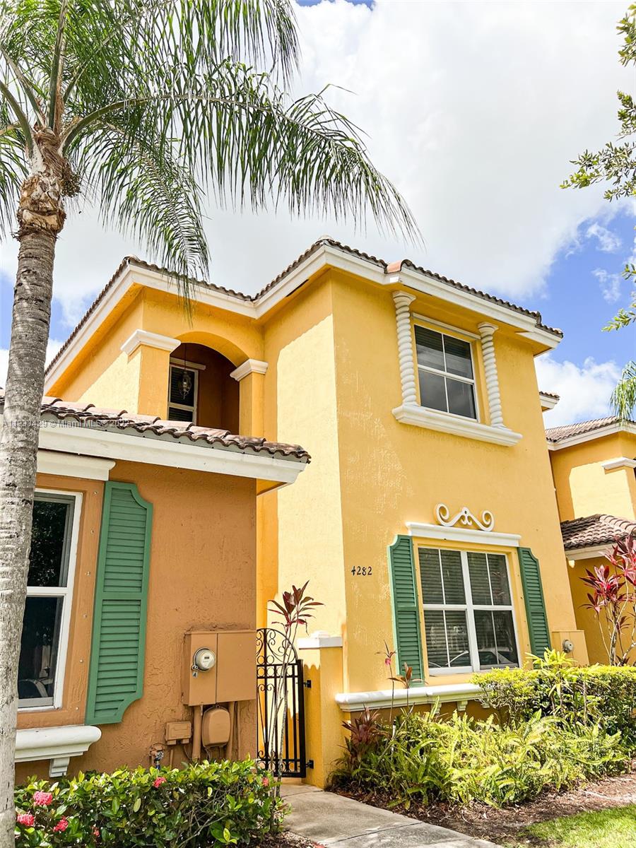 4282 Northeast 9th Street, Unit 4282 Homestead, FL 33033 - Photo 2 of 28 a front view of a house with a garden