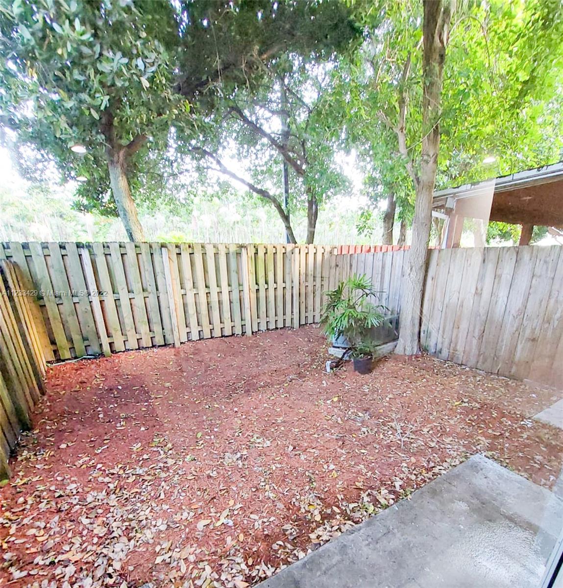 4282 Northeast 9th Street, Unit 4282 Homestead, FL 33033 - Photo 25 of 28 a view of backyard with green space and wooden fence