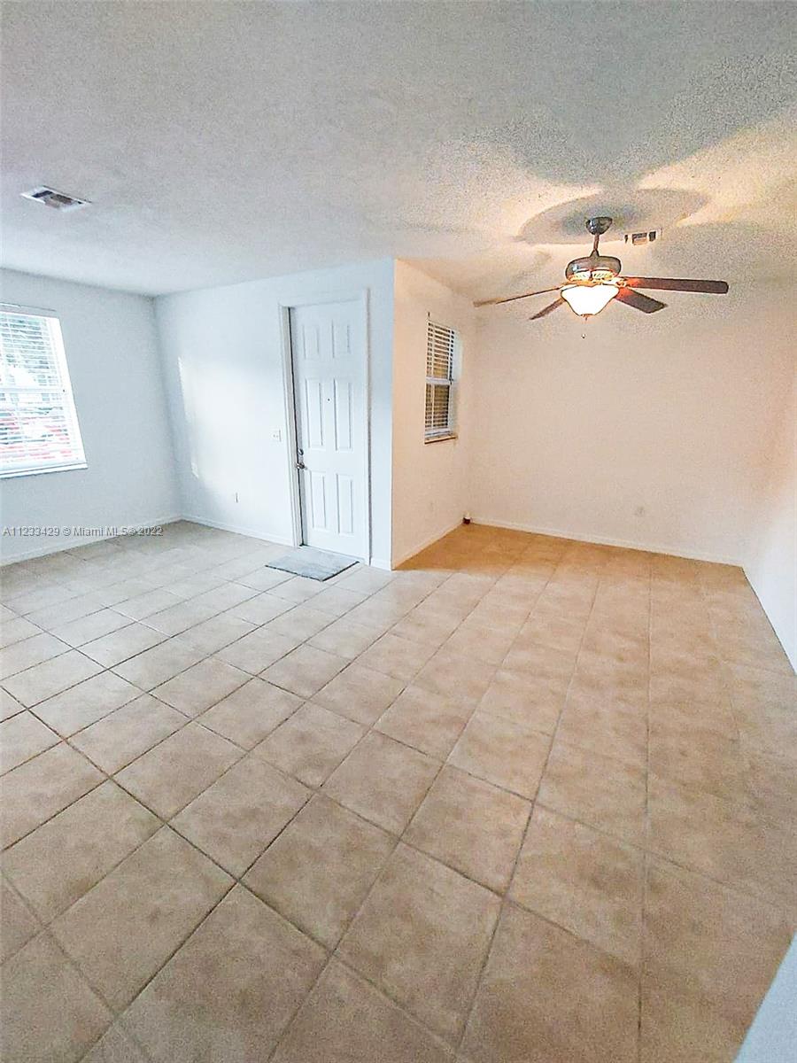 4282 Northeast 9th Street, Unit 4282 Homestead, FL 33033 - Photo 6 of 28 an empty room with windows and fan